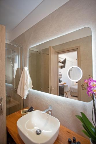a bathroom with a sink and a mirror at Mykonos Windmills View in Megali Ammos