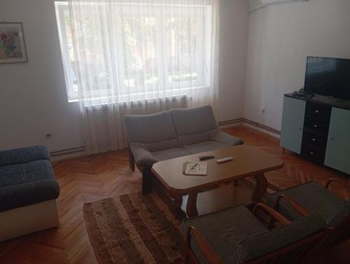 a living room with a couch and a coffee table at MAM apartmani in Bosanski Brod