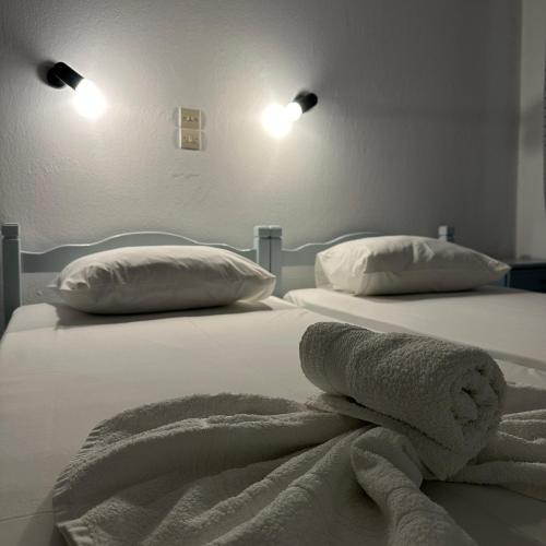 two beds with towels on them in a bedroom at Villa Eleni - Thassos Town in Limenas