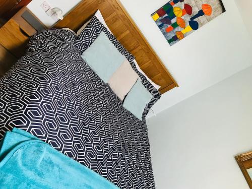 a bedroom with a bed and a mirror at Pisgah Guesthouse Snowdonia in Blaenau-Ffestiniog