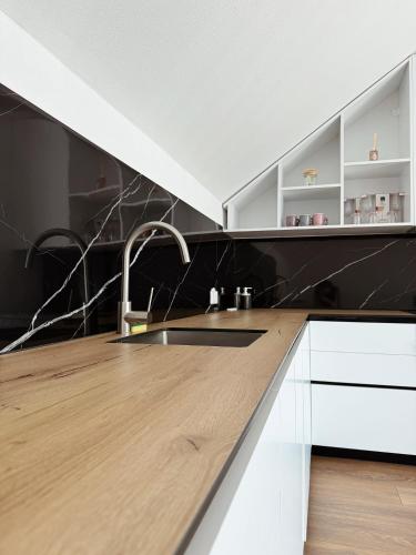 a kitchen with a sink and a wooden counter top at Peaceful Place Near Lake in Sankt Pölten