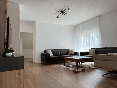 a living room with a couch and a table at Peaceful Place Near Lake in Sankt Pölten