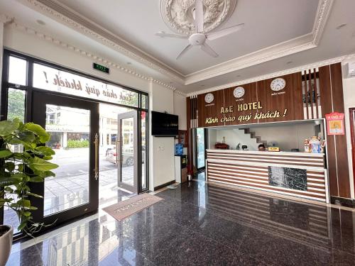a restaurant lobby with a large window and a counter at A&E Hotel in Móng Cái