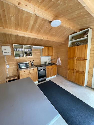 a kitchen with wooden cabinets and a table at Paatsalu Sadam in Paatsalu