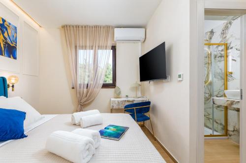 a bedroom with a bed with towels on it at Wine house apartments & rooms Marčeta in Fažana