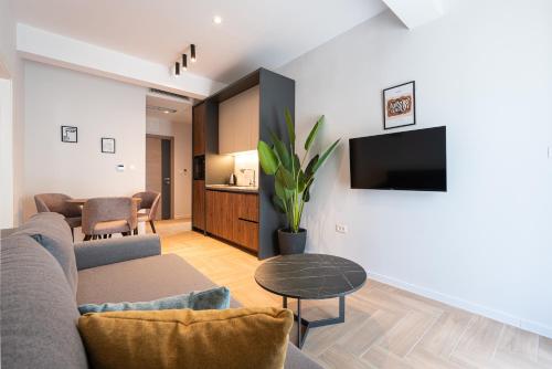 a living room with a couch and a tv at Bonita Residence in Dobrota