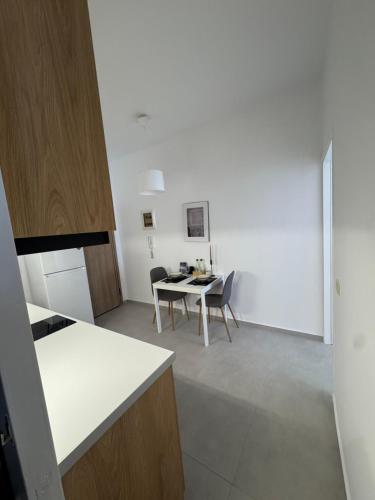 a kitchen and dining room with a table and chairs at Creta Apt Mela Β6 in Thérissos
