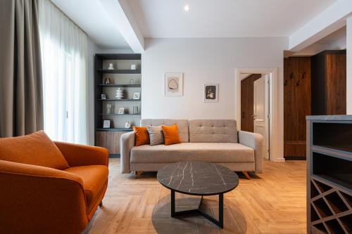 a living room with a couch and a table at Bonita Residence in Dobrota