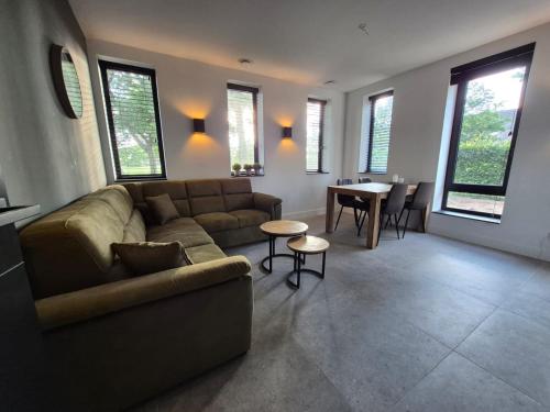 a living room with a couch and a table at Vakantiewoning OpdeBaan in Kaatsheuvel