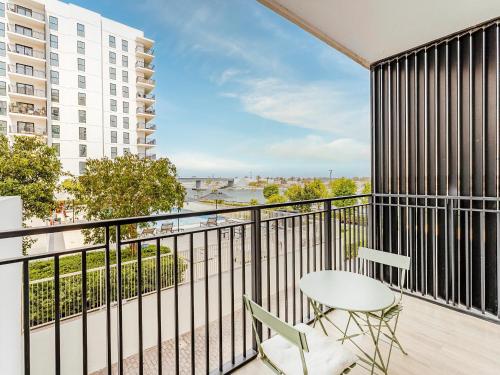 a balcony with a table and chairs and a view at Yas Island Tranquil Studio in Abu Dhabi