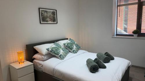 a bedroom with a bed with pillows on it at Ultra-Central Loft Penthouse Sky Sports & Movies in Leeds