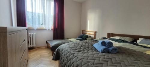 a bedroom with two beds with blue towels on it at Apartament Morze Bałtyckie in Gdańsk