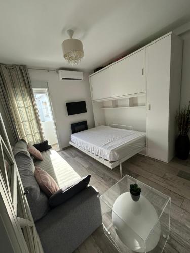 a living room with a bed and a couch at Loft Barbate in Barbate