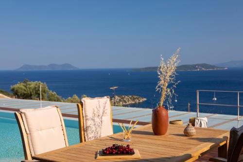 a wooden table with a vase of fruit on it at 2S Villas Resort - Cave Villas in Sivota