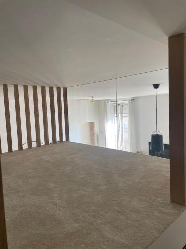 an empty room with a large bed in it at l atypique d Édouard in Grenoble