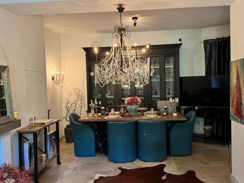 a dining room with a table and a chandelier at Historic Town Luxe and Epic View in Clausen