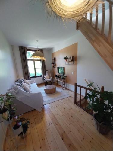 a living room with a bed and a couch in a room at Entre temps et pavés in Huy