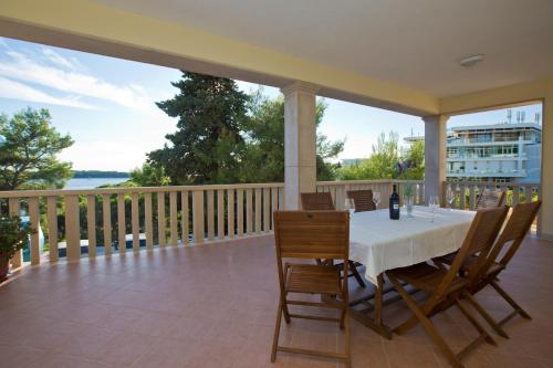 a dining table on a balcony with a view of the water at Villa Malisko in Hvar
