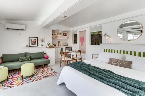 a bedroom with a bed and a living room at 5 Blocks to El Paseo Palm Desert Casita with Pool in Palm Desert