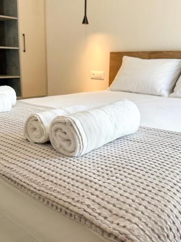a bedroom with a bed with towels on it at Gialos Villas Paleochora in Palaiochóra