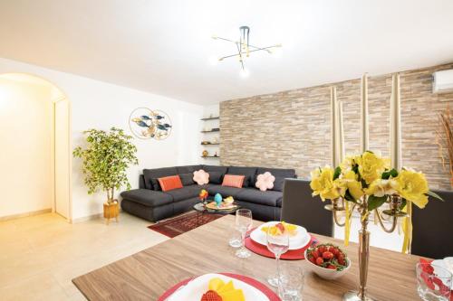 a living room with a couch and a table at Fantastic Loft in Sardinia with wifi and parking in Tertenìa
