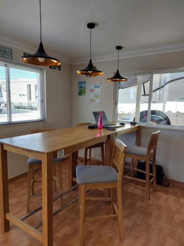 a kitchen with a large wooden table and chairs at Casinha da Galé in Galé