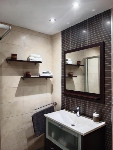 a bathroom with a sink and a mirror at Nules Beach Apartment in Moncófar