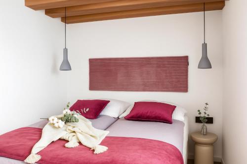 a bedroom with a white bed with red pillows at Ferienwohnung Wellnessblick - Nähe Triberger Wasserfälle in Triberg