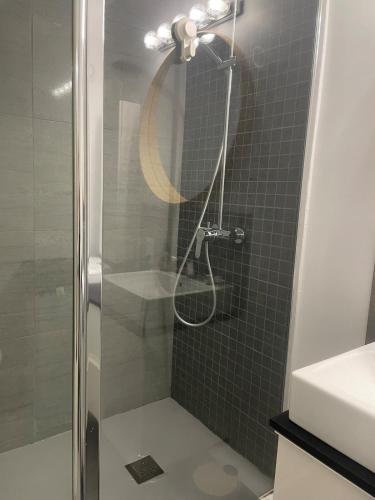 a bathroom with a shower with a glass door at Studio Vue Mer, Vélos, Terrasse, Ascenseur et Garage 6mn à pied in La Grande-Motte
