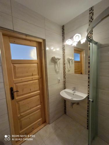 a bathroom with a sink and a shower at Stramówka in Groń