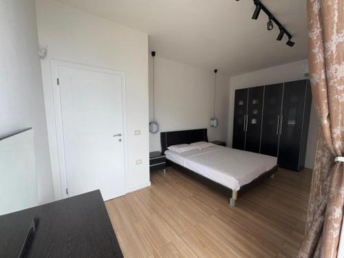 a bedroom with a bed and a large door at Villa Horizon Dhermi in Dhërmi
