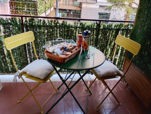 a table with a basket of food and two chairs at Mare Incanto in Gragnano
