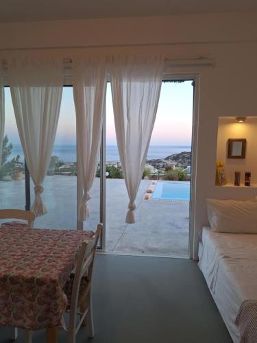 a bedroom with a bed and a view of the ocean at Villa Constantinos in Koutsounari