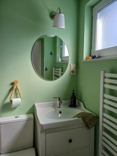 a bathroom with a sink and a mirror at Apartament Pomeranka Puck in Puck