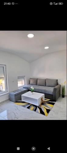 a living room with a couch and a coffee table at Apartman Centar Visegrad in Višegrad
