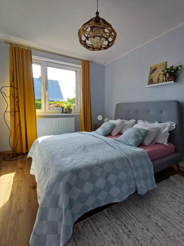 a bedroom with a bed and a window at Apartament Pomeranka Puck in Puck