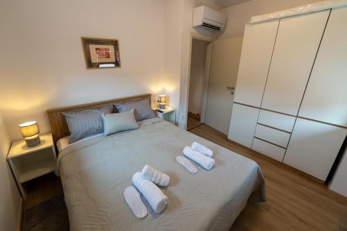 a bedroom with a bed with two towels on it at Apartman Ulika&Foška in Pazin