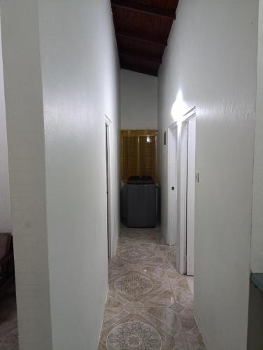 a hallway with white walls and a floor with a hallwayngthngthngthngthngth at d Abode Plains Saint Patrick in Elie Hall