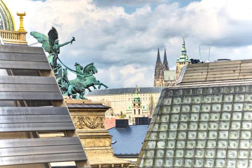 a view of the city of london with a statue at Ostrovni 7 Apartments in Prague