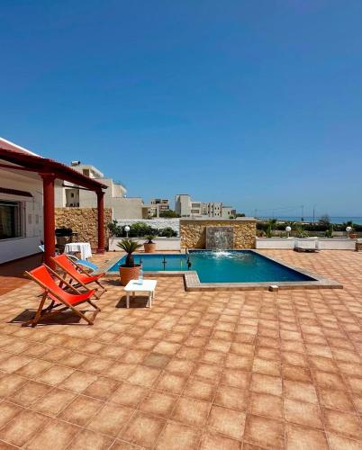 a patio with chairs and a swimming pool at Dar kerkwen in Bin Rhilouf