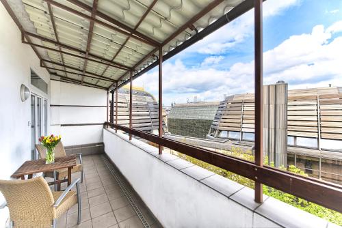 a balcony with a table and a view of the city at Ostrovni 7 Apartments in Prague