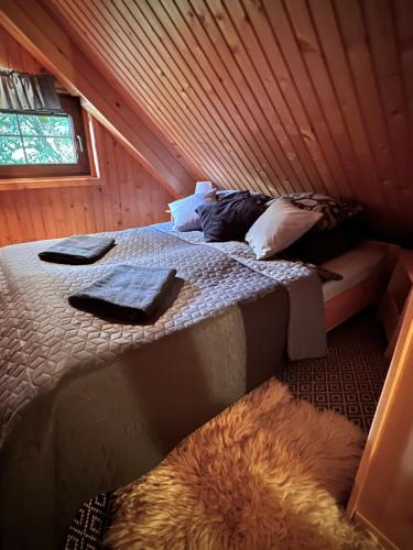 a bedroom with a bed in a wooden cabin at Chalúpka u líšky Elišky in Ždiar