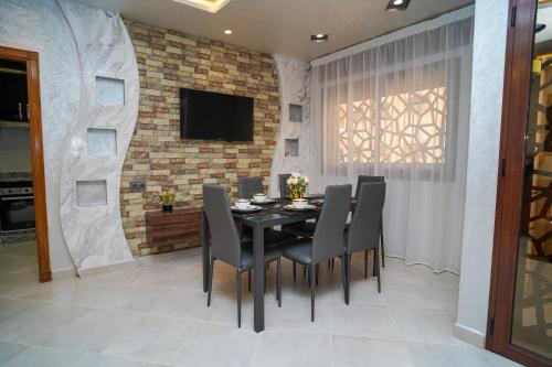 a dining room with a black table and chairs at Luxury apartment in Tangier 2 in Tangier