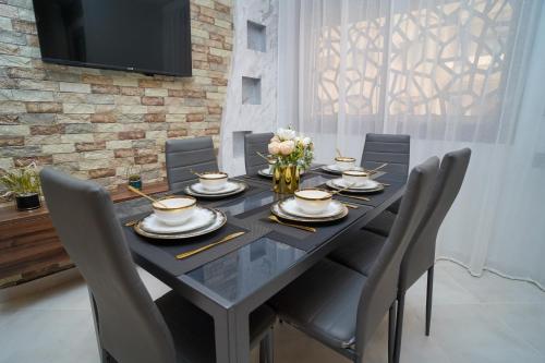 a dining room with a black table and chairs at Luxury apartment in Tangier 2 in Tangier