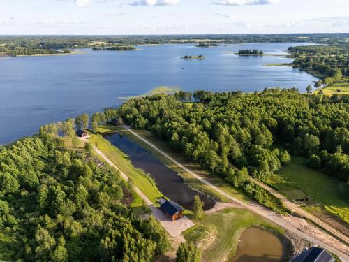 an aerial view of a lake with a farm at Galuonų vilos in Inturkė