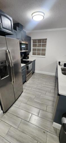 a kitchen with stainless steel appliances and tile floors at Heart of Tampa in Tampa