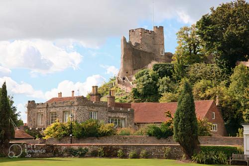 a castle on the hill behind a house at Elegant Apartment in Historic Georgian Townhouse in Lewes