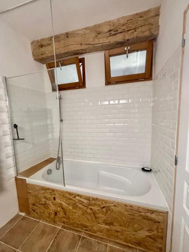 a bathroom with a large tub in a room at Logement entier dans les Corbières in Coustouge
