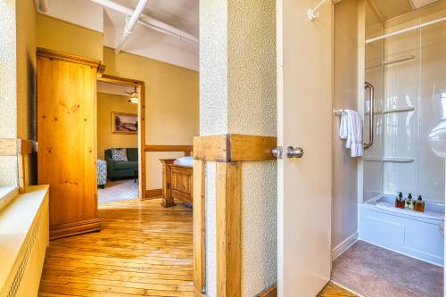 a bathroom with a shower and a glass door at The Stratford Hotel by Hoco Hotels Collection in Stratford