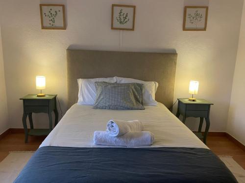 a bedroom with a large bed with two night stands at Casa na Quinta in Elvas